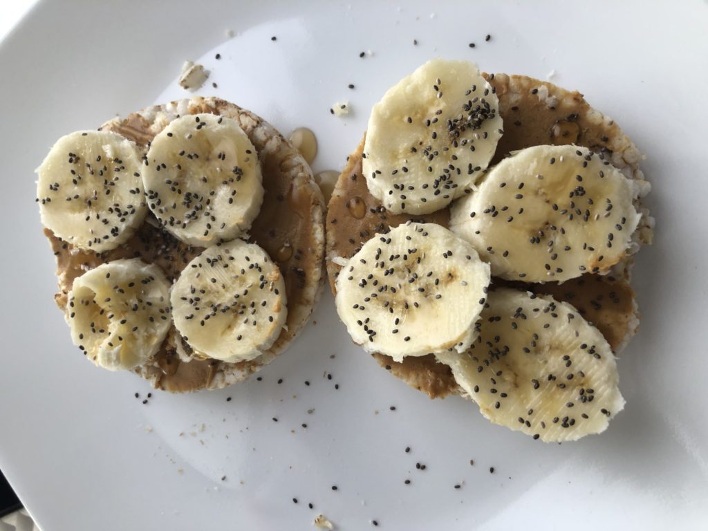 Organice rice cake with peanut butter topped with banana.